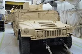 AcraStrip 600 Military a tan military vehicle in a sterile white room